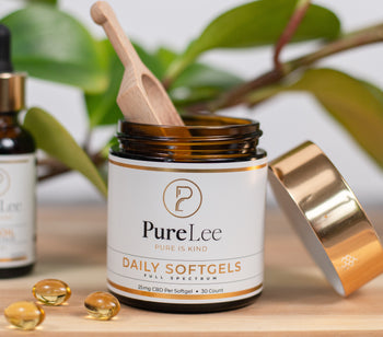 PureLee Farms Premium CBD Oil Tinctures and Softgels showcased with plant in the background